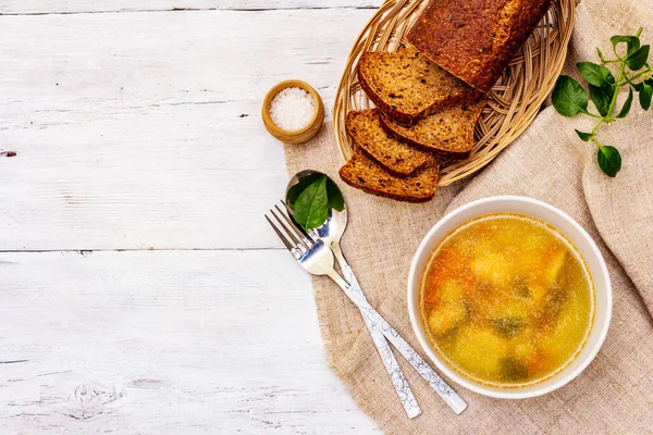 Trout soup with cutting vegetables and toasted bread. Traditional hot fish soup for healthy lifestyle. White wooden boards background, top view — Stock Image Trout Soup Cutting Vegetables Toasted Bread Traditional Hot Fish Soup Stock Picture