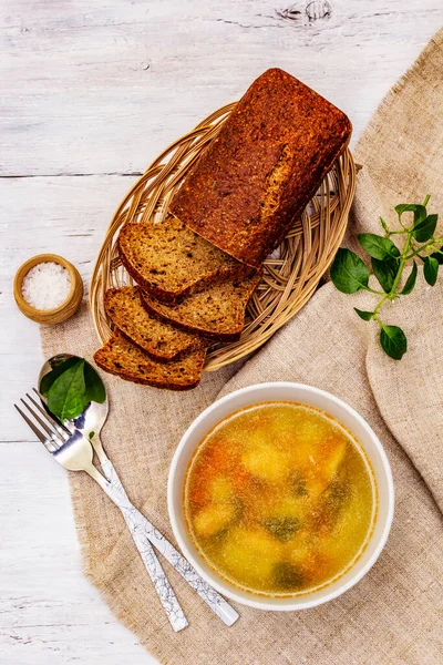 Trout soup with cutting vegetables and toasted bread. Traditional hot fish soup for healthy lifestyle. White wooden boards background, top view — Stock Image Trout Soup Cutting Vegetables Toasted Bread Traditional Hot Fish Soup Stock Photo