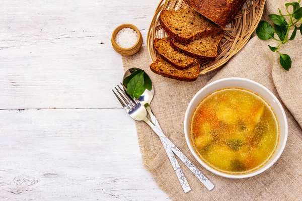 Trout soup with cutting vegetables and toasted bread. Traditional hot fish soup for healthy lifestyle. White wooden boards background, top view — Stock Image Trout Soup Cutting Vegetables Toasted Bread Traditional Hot Fish Soup Royalty Free Stock Photos