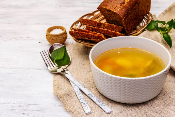 Trout soup with cutting vegetables and toasted bread. Traditional hot fish soup for healthy lifestyle. White wooden boards background, close up — Stock Image Trout Soup Cutting Vegetables Toasted Bread Traditional Hot Fish Soup Royalty Free Stock Images