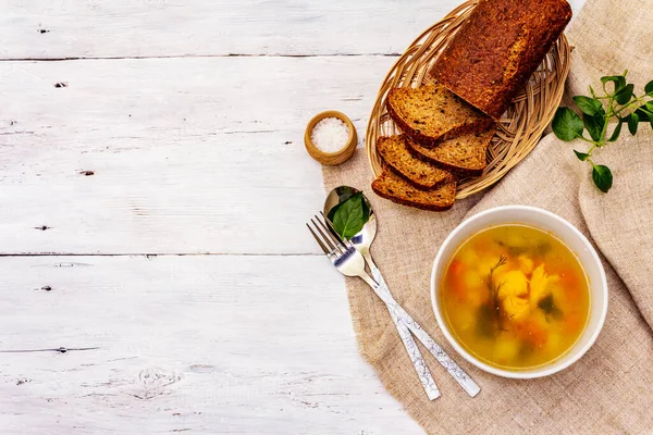 Trout soup with cutting vegetables and toasted bread. Traditional hot fish soup for healthy lifestyle. White wooden boards background, top view — Stock Image Trout Soup Cutting Vegetables Toasted Bread Traditional Hot Fish Soup Stock Image