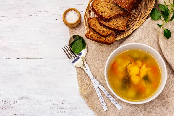 Trout soup with cutting vegetables and toasted bread. Traditional hot fish soup for healthy lifestyle. White wooden boards background, top view — Stock Image Trout Soup Cutting Vegetables Toasted Bread Traditional Hot Fish Soup Stock Photo
