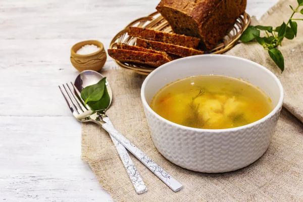Trout soup with cutting vegetables and toasted bread. Traditional hot fish soup for healthy lifestyle. White wooden boards background, close up — Stock Image Trout Soup Cutting Vegetables Toasted Bread Traditional Hot Fish Soup Stock Photo