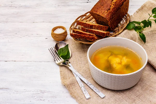 Trout soup with cutting vegetables and toasted bread. Traditional hot fish soup for healthy lifestyle. White wooden boards background, copy space — Stock Image Trout Soup Cutting Vegetables Toasted Bread Traditional Hot Fish Soup Stock Image