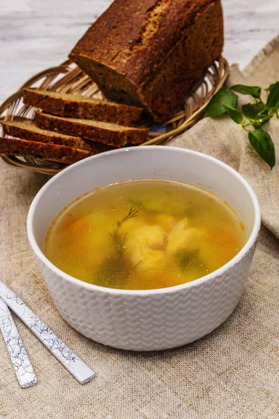Trout soup with cutting vegetables and toasted bread. Traditional hot fish soup for healthy lifestyle. White wooden boards background, close up — Stock Image Trout Soup Cutting Vegetables Toasted Bread Traditional Hot Fish Soup Royalty Free Stock Photos