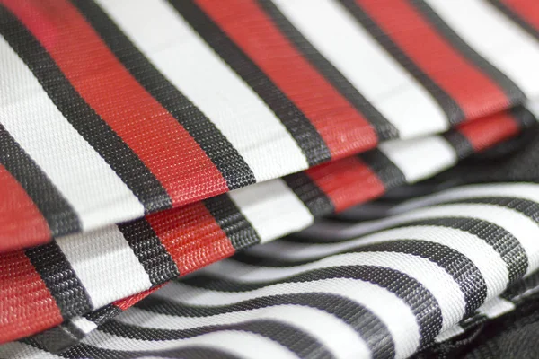 Detail of nylon bags with red and black stripes. Saara, Rio de Janeiro, Brazil. 2019