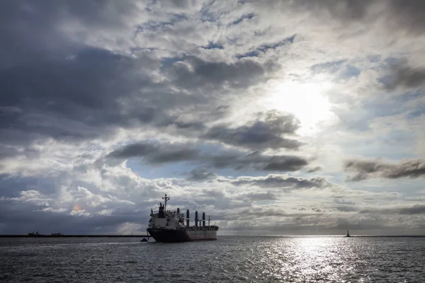 sunset into the sea with the Container ship Silhouette