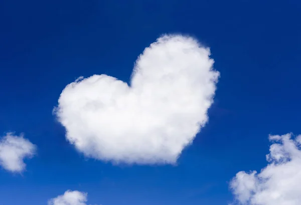 heart shaped cloud on bright blue sky white clouds
