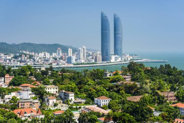 Gulangyu Adası 'nın havadan görünüşü ve Xiamen, Çin kıyıları boyunca uzanan modern binalar..