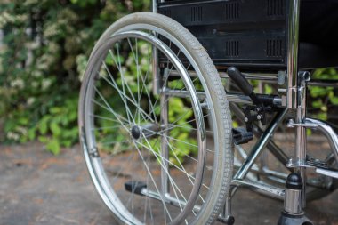 Tekerlekli sandalye dışarıda, tuğla zeminde bir parkta