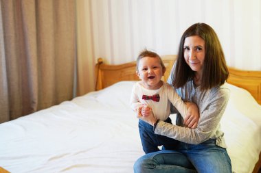 Kadın sevimli bebeğine sarılıyor, tatlı çocuk kameraya gülümsüyor, fotokopi çekiyor. annelik kavramı