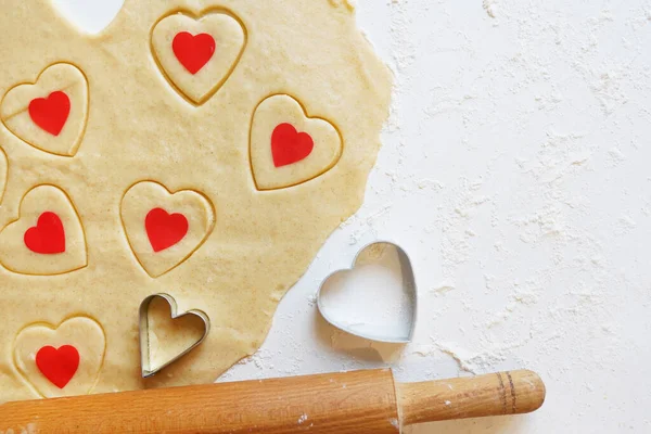 Baking love heart cookies for Valentine day. Top view