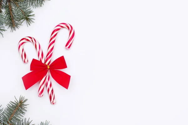 Candy cane with red bow on white background with copy space