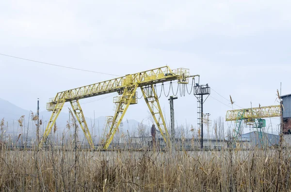 Yellow gantry crane with construction elements