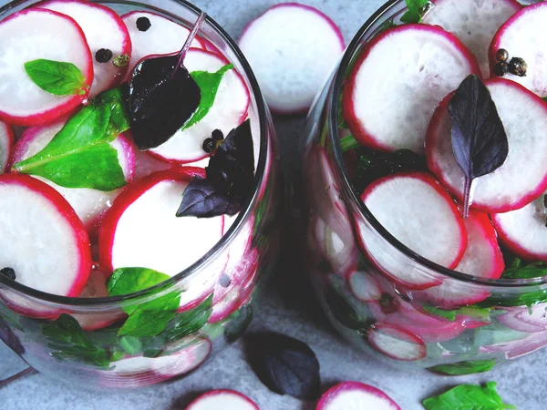 Salad in the jar. Fitness salad with radish and spinach. Food containing fiber.