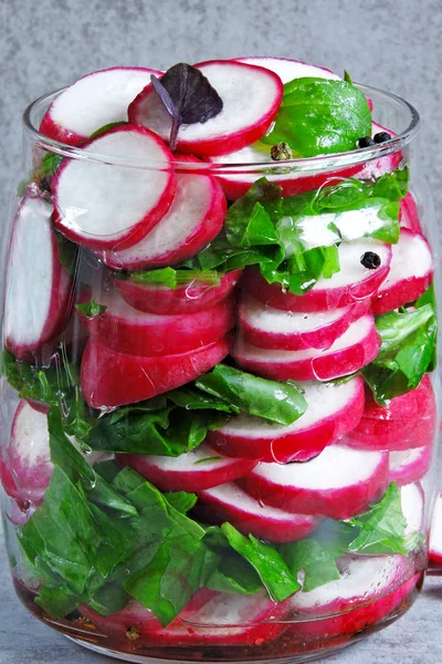 Salad in the jar. Fitness salad with radish and spinach. Food containing fiber.