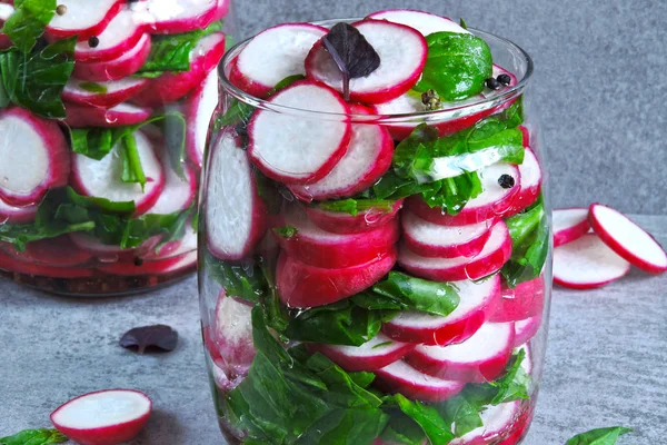 Salad in the jar. Fitness salad with radish and spinach. Food containing fiber.