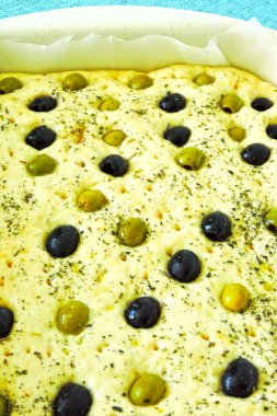 Pişirme işlemi focaccia zeytinli. Bir fırın tepsisine ham çeşitler.