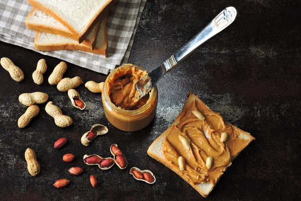 Peanut paste and peanuts. Vegan snack. Keto snack. Vegetable protein concept.