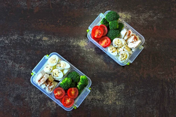 Lunch boxes with a healthy meal. Vegetables, quail eggs and chicken breast. Lunch boxes to go.