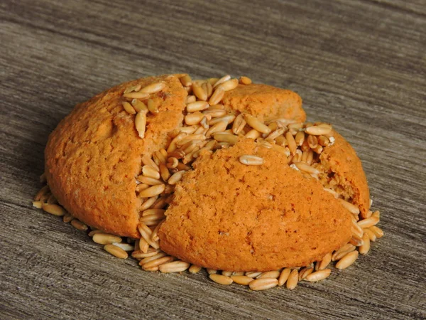 Oatmeal cookies filled with grains of oats. Nutrition for weight reduction. Grain of oats around cookie. Macro. Copy space.