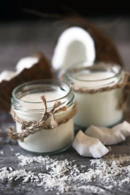 Keto diyeti. Keto içiyor. Kavanozlar dolusu hindistan cevizi sütü, hindistan cevizi gevreği, hindistan cevizi. Hindistan cevizi sütü. Vejetaryen sütü.