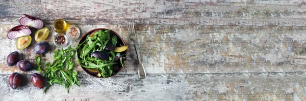 Light salad with arugula and plums. Autumn plum salad. Healthy food.