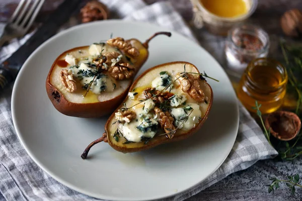 Baked pears with cheese and nuts. French cuisine. Healthy food. Vegetarian lunch.