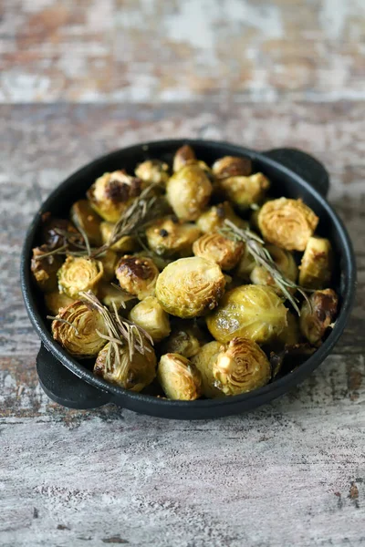 Baked Brussels sprouts with rosemary in a pan. Vega food. Healthly food.