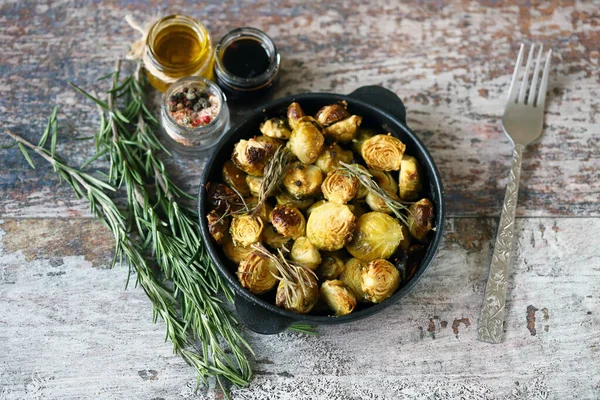 Baked Brussels sprouts with rosemary in a pan. Vega food. Healthly food.