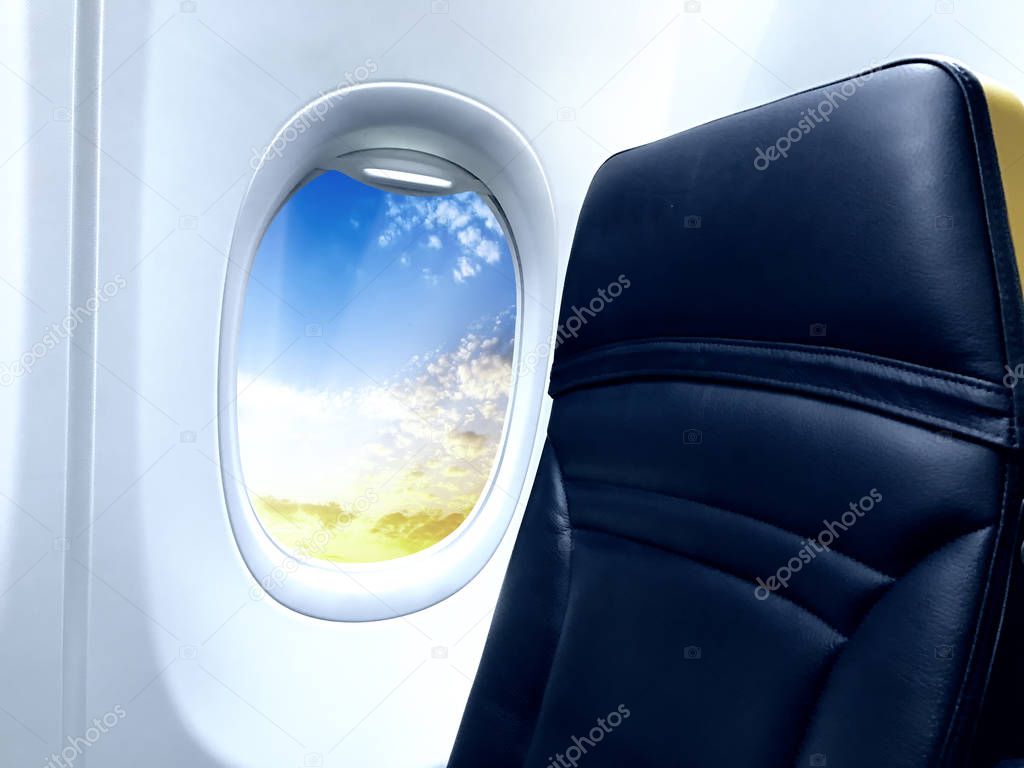 Airplane window with view on a beautiful sky.
