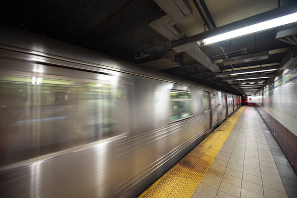 New York Subway train in transit in the station.