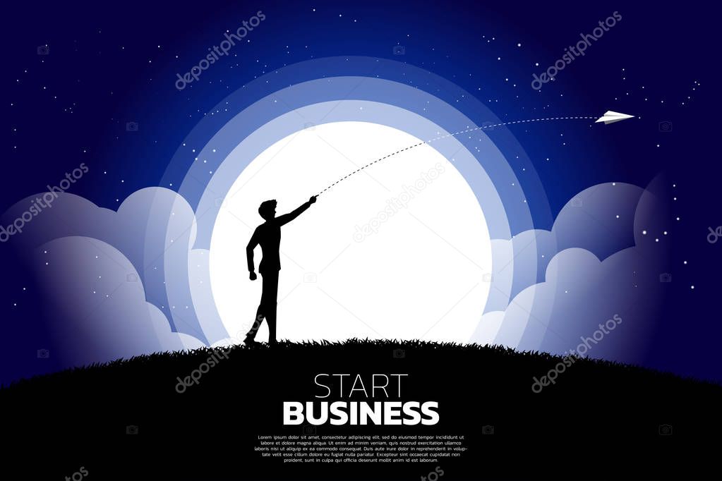 silhouette of businessman throw out origami paper airplane at night. Business Concept of start business and entrepreneur