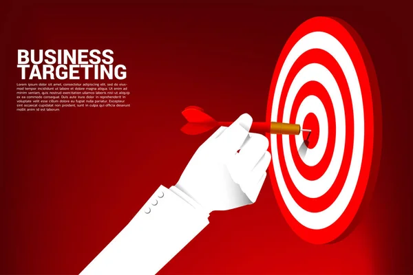 close up businessman hand with dart arrow to hit the dartboard. Business Concept of targeting and customer.Company vision mission.