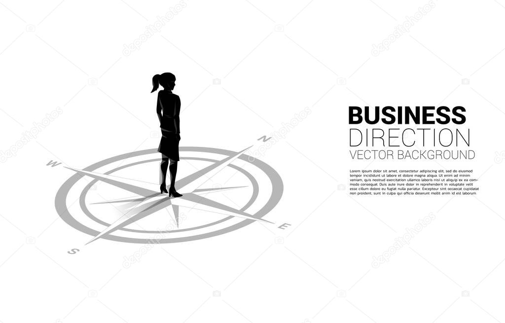Silhouette of businesswoman standing at center of compass on floor.Concept of career path and business direction