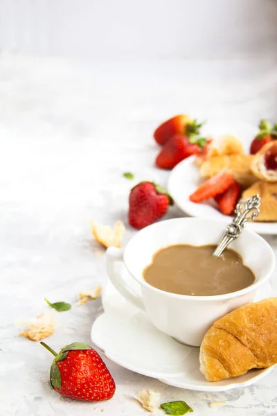 French Breakfast Dessert with a Cup of coffee Croissants Fresh Strawberry On a white Background CopySpace Beautiful table Setting Mother's day ,Valentine's Day