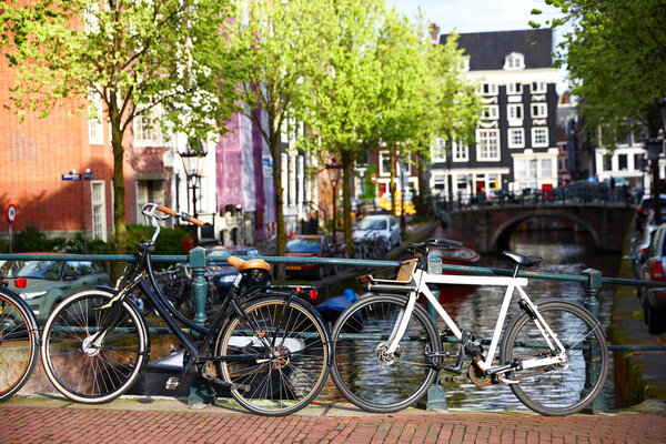 Amsterdam street canal with typical dutch houses and bikes. Holland, Netherlands