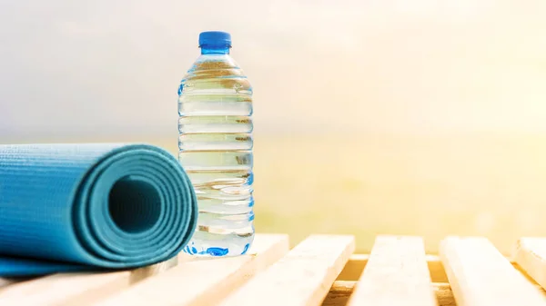 water bottle and sports mat outside