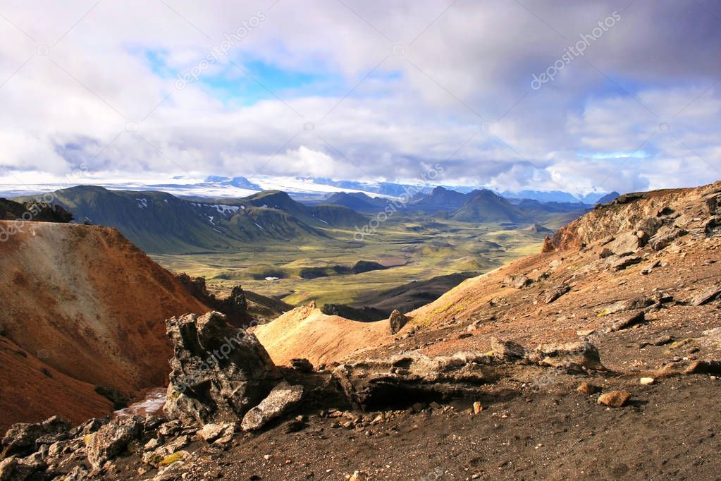 Orange rocks, green valley, hills and glacier in Landmannalaugar National Park, Iceland.