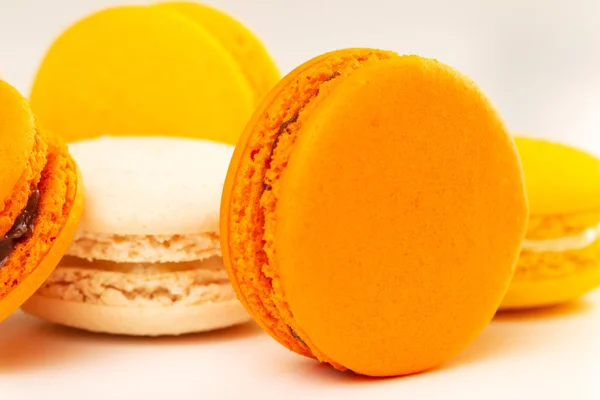 Orange and yellow macarons or macaroons stacked. Closeup. — Stock Photo, Image