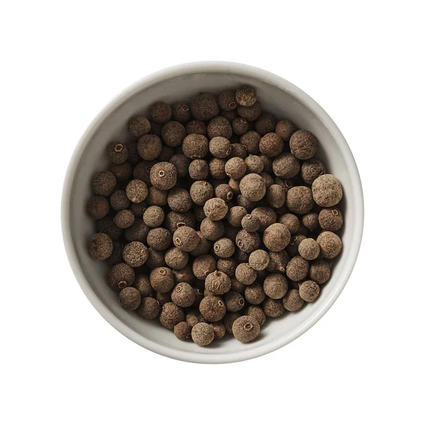 Allspice in bowl. Preparing ingredients for cooking. Isolated on white background. Top view. — Stock Photo, Image