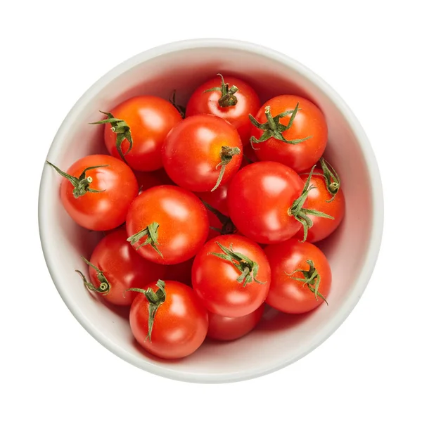 Fresh ripe tomatoes in ceramic bowl isolated on white background with green leaf. Ingredients for cooking. Top view. — Stock Photo, Image