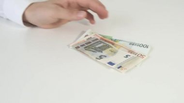 Masaya para koyan kişi elleri. Euro ve dolar.