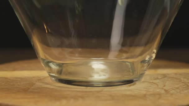 Ein Ei in eine Glasschüssel brechen. Nahaufnahme — Stockvideo