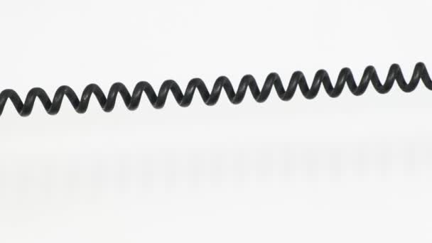 Close up of rotary phone coiled cord on white — Stock Video