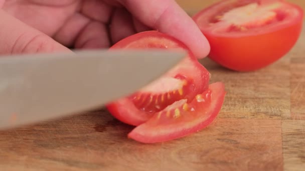 Tomate coupant en gros plan. Chef tranche la tomate cerise. — Video