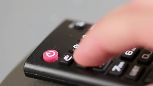 Pressing the backward button on the tv remote control. Watching television. close up — Stock Video