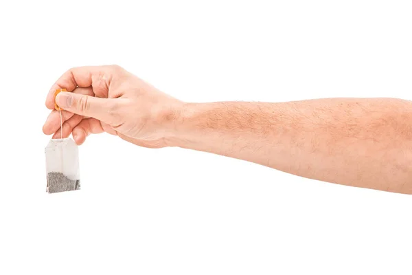 Man hand houden theezakje geïsoleerd op witte achtergrond — Stockfoto