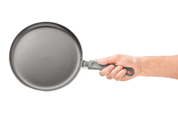 Hand holding a black frying pan isolated on white background — Stock Photo, Image