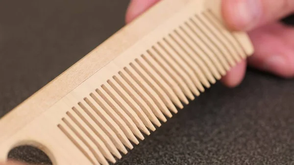 Thin comb of light wood on a white background. close up — Stock Photo, Image